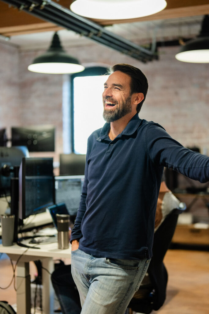 Man stands laughing in office at Startup Virginia